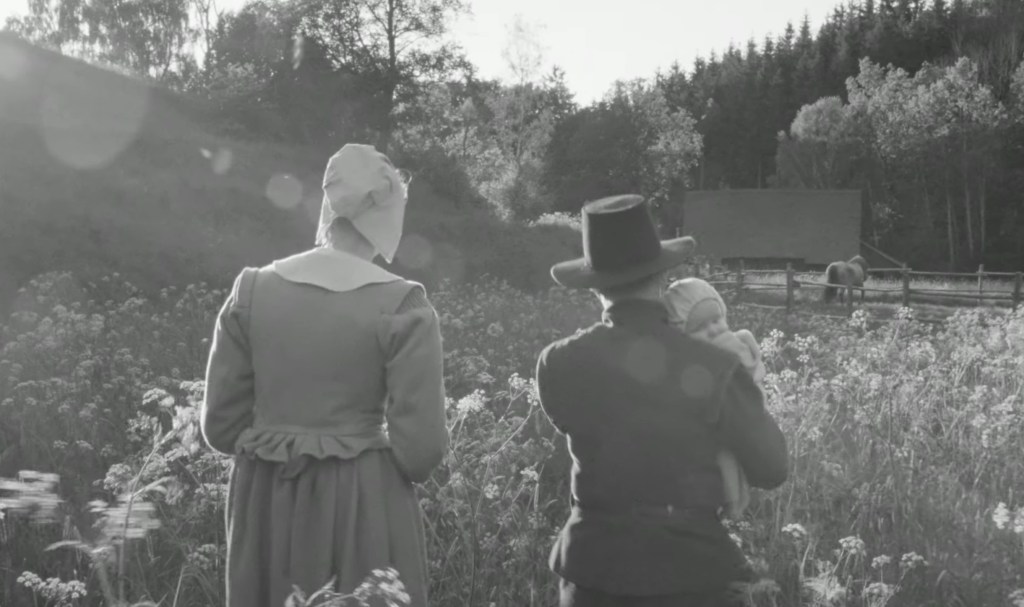 Rose walks through the countryside with her family, alongside her spouse and their baby.